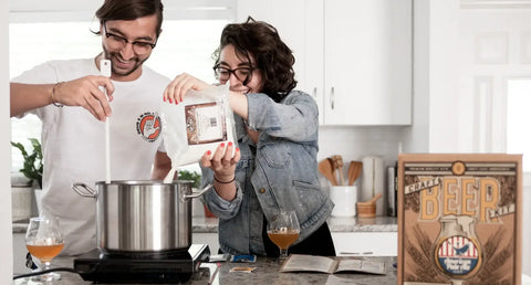 Couple brewing beer with the Craft a Brew 1 Gallon Beer Brewing Kit